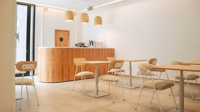 Cafetería con mostrador de madera y mesas